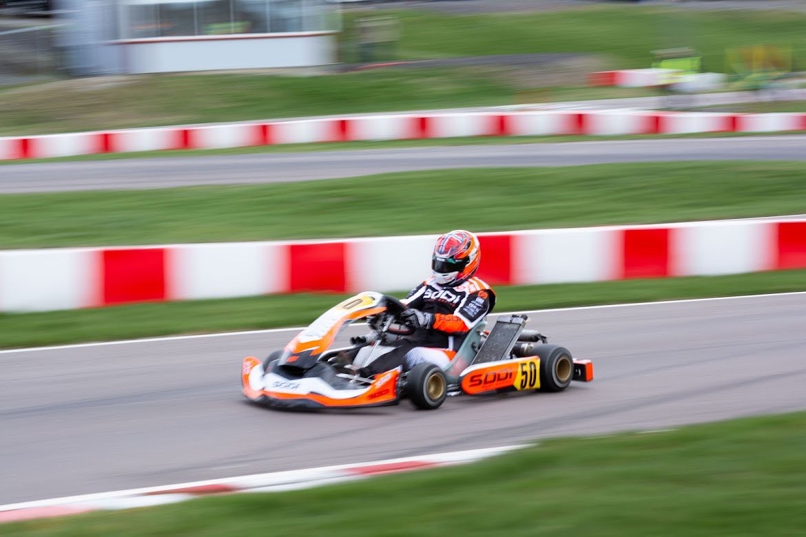 #50 driver on track wearing a custom-designed race helmet