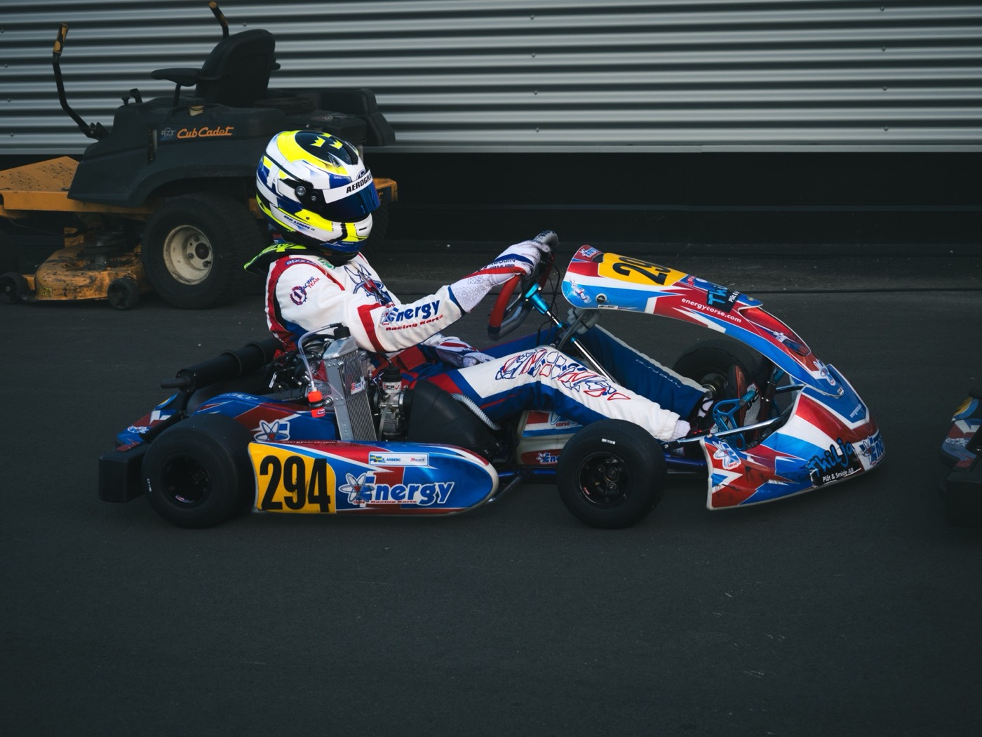 #294 driver on track wearing a custom-designed race helmet